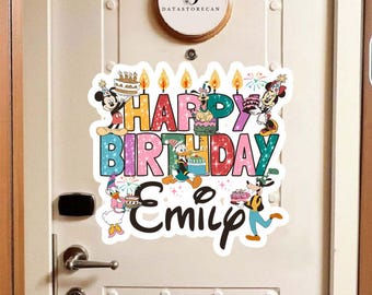 May include: A colorful birthday door decoration featuring the text "HAPPY BIRTHDAY Emily" with Disney characters like Mickey Mouse, Minnie Mouse, Donald Duck, and Goofy. The design includes birthday cakes and candles.