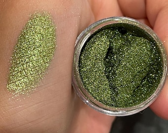 May include: A small jar of green glitter with a sample of the glitter on a fingertip.