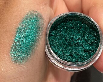 May include: A small jar of green glitter eyeshadow with a sample of the glitter applied to the skin.