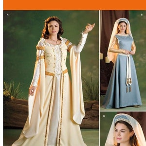 Könnte beinhalten: Simplicity Schnittmuster Nummer 2573 für ein mittelalterliches Kleid. Das Schnittmuster umfasst zwei verschiedene Stile, einen mit einem langen, fließenden Rock und einen mit einem kürzeren, figurbetonten Rock. Beide Stile haben lange Ärmel und einen hohen Ausschnitt.