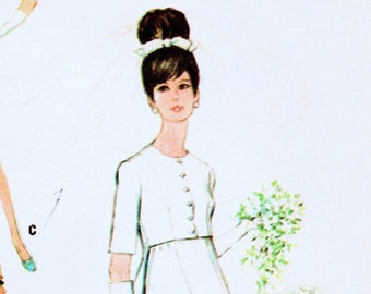 May include: A vintage sewing pattern featuring four different dress designs. The dresses are all long and have a simple, elegant style. The pattern includes instructions for making a white wedding dress, a pink dress with a matching jacket, a blue dress, and a green dress with a leopard print.