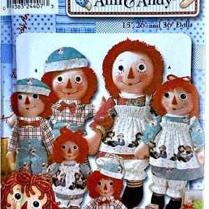 May include: A pattern for Raggedy Ann & Andy dolls in various sizes. The image shows several dolls with red yarn hair, button eyes, and painted smiles. The dolls are wearing dresses and overalls. The pattern includes sizes 38 cm, 66 cm, and 91 cm.