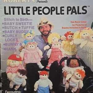 May include: A vintage magazine cover featuring Xavier Roberts and several Little People Pals dolls. The dolls have various hairstyles and outfits. Text includes "Little People Pals," "Collector's Edition," and doll names like "Baby Sweetie" and "Butch."
