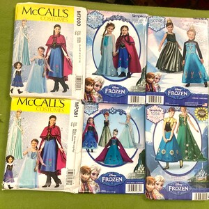 May include: Six sewing pattern envelopes featuring Disney Frozen character costumes. The collection includes McCall's M7000 and MP381, Simplicity C0733, S0748, C0734, and 1094. Each envelope displays illustrations of dresses, capes, and outfits for children and dolls.