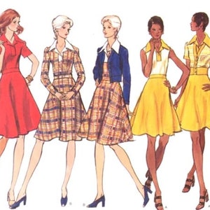 May include: Five women wearing different styles of dresses. The dresses are all knee-length and have a variety of colors and patterns. The women are all standing in a row and looking at the camera.