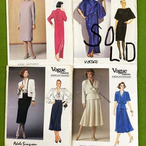 May include: Four Vogue Patterns American Designer sewing pattern envelopes featuring illustrations of various dresses and skirt suits. The envelopes display designs by John Anthony, Kasper, and Adele Simpson, with visible text including pattern numbers.