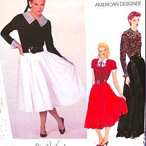 May include: Three women's sewing patterns for dresses. The patterns are from American Designer. The first pattern is for a white skirt with a black top and a large collar. The second pattern is for a red skirt with a white top and a bow. The third pattern is for a black skirt with a striped top. The pattern numbers are 2871 and Edith Head.