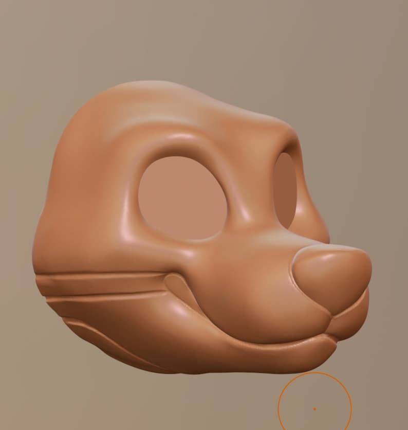 Op de afbeelding: Een 3D-model van een cartoon dierenkop, waarschijnlijk een vos of een hond, in een lichtbruine kleur met grote, lege oogkassen.