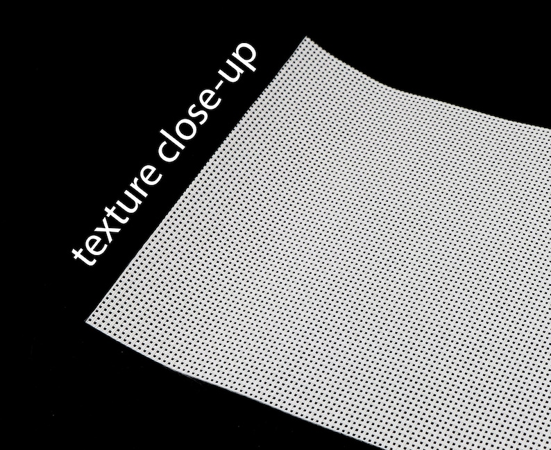 May include: Close-up of a white fabric with a fine, evenly spaced dot pattern. The fabric has a smooth, slightly textured surface.
