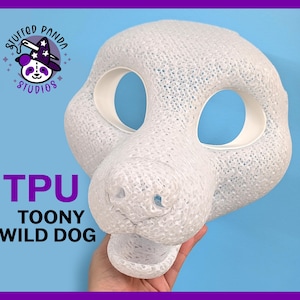 May include: A white TPU Toony Wild Dog mask with large eye openings and a textured surface. The mask is held by a hand against a blue background, with the text "TPU TOONY WILD DOG" in purple.