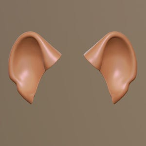 Puede incluir: Dos orejas de color marrón claro, modeladas en 3D, probablemente para un disfraz o accesorio, se muestran sobre un fondo neutro. Las orejas tienen un diseño suave y curvado, con un ligero brillo, lo que sugiere una apariencia realista. La estética general es simple y limpia.