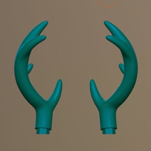 May include: A pair of teal green deer antlers, made of plastic, with a smooth, rounded surface.