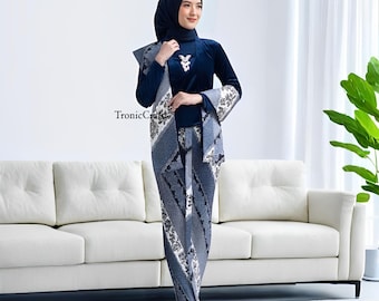 May include: A navy blue ensemble featuring a long-sleeved top, matching skirt, and a patterned shawl. The top has a high neckline and a decorative brooch. The skirt and shawl display a white and gray floral design. The outfit is suitable for modest wear.