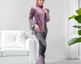 May include: A mauve velvet ensemble featuring a long-sleeved top with bell sleeves and a matching pair of pants. The top has a high collar and a decorative trim. The pants have a patterned design. The outfit is worn with a matching head covering.