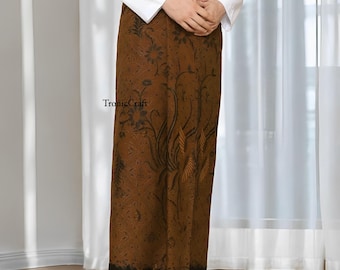 May include: A brown sarong with a floral pattern and the text "TronicCraft". The sarong is a wrap-around garment, likely made of fabric. The design features dark brown floral and leaf motifs.