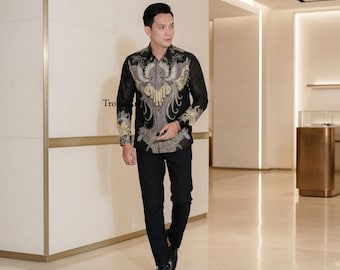 May include: A black button-down shirt with a detailed, ornate design in shades of gold, gray, and white. The shirt is paired with black dress pants and black shoes. The shirt features a unique, patterned design.