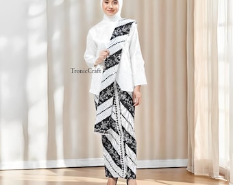 May include: A woman wearing a white blouse, head covering, and a black and white patterned skirt and shawl. The skirt and shawl feature a geometric and floral design. The text "TronicCraft" is visible on the image.
