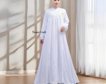 May include: A white maxi dress with a lace overlay and a high neckline. The dress has long sleeves and a flowing skirt. The dress is made of a lightweight fabric and is perfect for a special occasion.