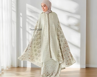 May include: A white prayer shawl with a floral pattern and a hood. The shawl has a zipper closure and a long, flowing design. The text "TronicCraft" is visible in the image.