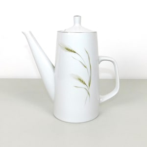 May include: White ceramic coffee pot with a silver trim and a design of green wheat stalks.