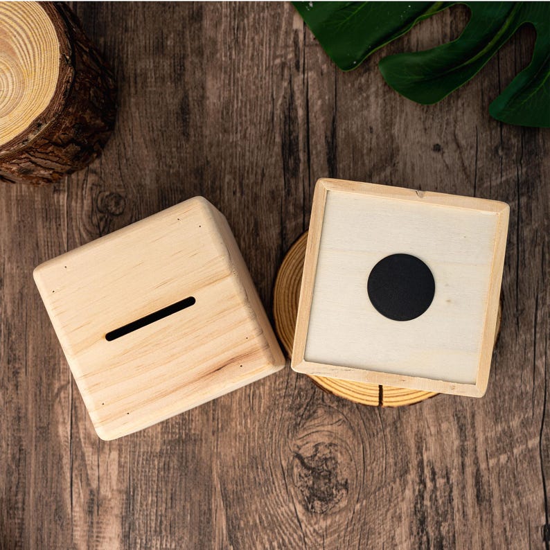 May include: Two wooden boxes with lids. One box has a slot on the top and the other has a round hole in the lid.