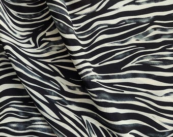 May include: Black and white zebra print fabric with a soft, flowing texture. The fabric has a subtle watercolor effect, giving it a unique and stylish look.