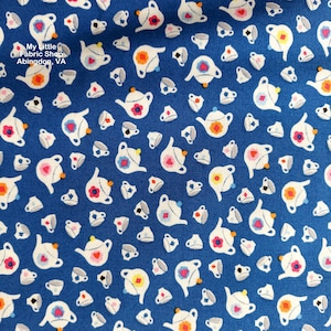 May include: A blue fabric with a white teapot and cup pattern. The teapots have a pink heart, yellow and orange flower, and white accents. The cups have a black rim and a white interior.
