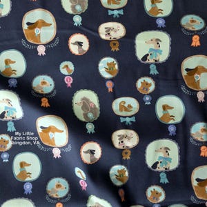 May include: Dark navy fabric featuring a repeating pattern of different dog breeds in oval and rectangular frames. Each dog is shown with a ribbon or bow. The fabric also features the text "My Little Fabric Shop, Abingdon, VA."