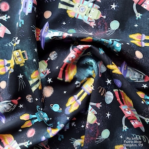 May include: A black fabric with a repeating pattern of robots, stars, and planets. The robots are in various colors, including red, blue, green, and yellow. The fabric has a whimsical and fun design.