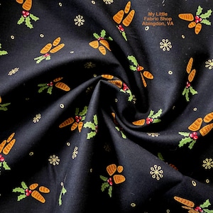 May include: Dark navy fabric with a repeating pattern of orange pinecones, green holly leaves, red berries, and gold snowflakes. The fabric has a slight sheen and is folded, showing texture. The text "My Little Fabric Shop Abingdon, VA" is visible.