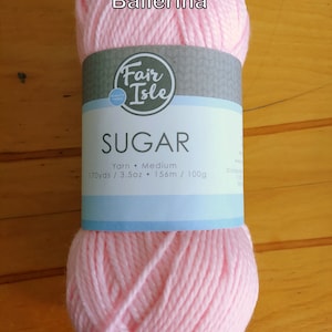 May include: A pink ball of Fair Isle Sugar yarn labelled "Ballerina". The yarn is medium weight and has 170 yards / 3.5 ounces or 156 metres / 100 grams.