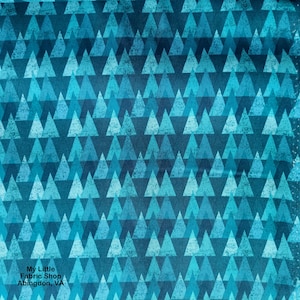May include: A blue and teal fabric with a repeating pattern of triangles. The triangles are arranged in a staggered pattern, creating a sense of depth and texture. The fabric has a slightly distressed look, giving it a vintage feel.