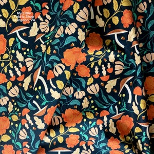 May include: Dark navy fabric with a repeating pattern of orange flowers, mushrooms, and leaves in shades of cream, yellow, and teal. The text "My Little Fabric Shop Abingdon, VA" is visible in the upper left corner.