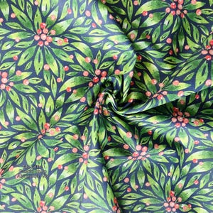May include: Close-up of fabric with a repeating pattern of green leaves and red berries on a dark blue background. The leaves are watercolor-style, with varying shades of green. The berries are small and round. The fabric is folded, creating shadows and depth.
