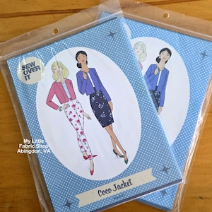 May include: Two identical sewing pattern envelopes for the Coco Jacket by Sew Over It, packaged in clear plastic. The blue covers feature white polka dots and an illustration of two figures wearing cropped jackets, one pink and one blue.