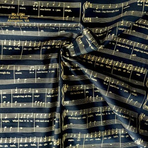 May include: Black fabric with gold musical notes printed on it. The fabric features the lyrics to the song "Jingle Bells" and the title "My Little Fabric Shop Abingdon, VA".