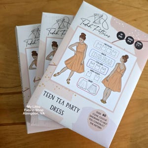 May include: Three packets of a Teen Tea Party Dress sewing pattern. The packets are white with peach illustrations of the dress. Text includes "Tedeh Patterns", "Teen Tea Party Dress", and "My Little Fabric Shop Abingdon, VA".