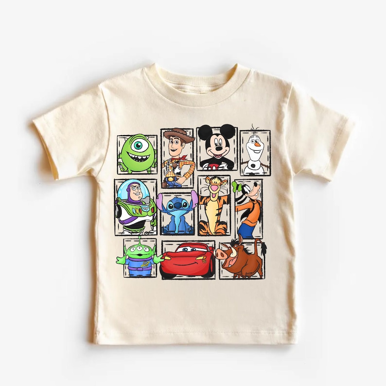 May include: Cream-colored t-shirt featuring a grid of cartoon characters including Mike Wazowski, Woody, Mickey Mouse, Olaf, Buzz Lightyear, Stitch, Tigger, and Goofy. Other characters include an alien, Lightning McQueen, and Pumbaa. The characters are in individual square frames.