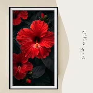 May include: A framed art print featuring vibrant red hibiscus flowers against a dark background of leaves. The flowers have detailed petals and yellow stamens. The words "NEW PRINT" are printed vertically on the right side of the frame.