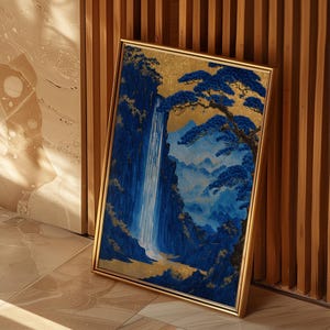 May include: A framed painting of a waterfall cascading down a mountainside, with a pine tree in the foreground. The painting is done in shades of blue and gold, with a gold frame.