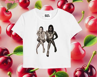 May include: White cropped t-shirt featuring a black and white photograph of two women. The text "Sweet Baby T's" is printed on the shirt.