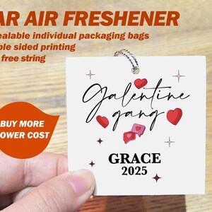 May include: A white car air freshener featuring the words "Galentine gang" and "GRACE 2025" in black script, with red heart and star designs. It has a string for hanging. The text "CAR AIR FRESHENER" is at the top.