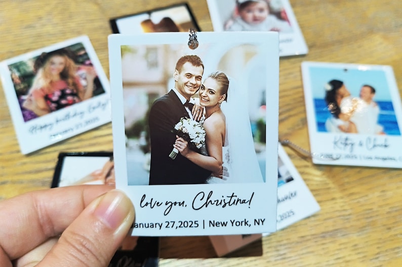 May include: A white photo frame with a picture of a couple in a wedding setting. The text "love you. Christina! January 27, 2025 | New York, NY" is printed on the frame.