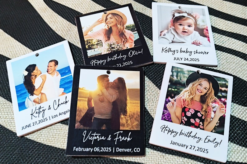 May include: Five black and white photo booth style cards with different images and text. The cards have a hole punched in the top left corner. The text on the cards includes names, dates, and events such as "Kathy & Chuck", "Happy birthday, Olivia!" and "Kathy's baby shower".