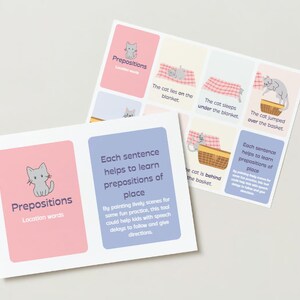 May include: Educational flashcards for learning prepositions. The cards feature illustrations of a gray cat in various positions, such as lying on a blanket or jumping over a basket. Text includes "Prepositions" and "Location words."