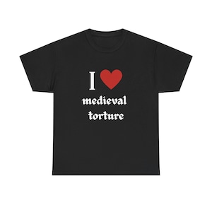 May include: Black t-shirt with the text "I ❤️ medieval torture" in white gothic font. The heart symbol is red. The shirt is a short-sleeved crew neck.