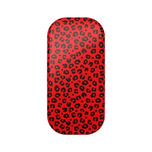 May include: A red rectangular phone grip with a black leopard print pattern. The grip has rounded corners and a smooth surface. The leopard print consists of black spots of varying sizes.