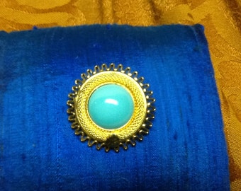 Beautiful blue stone is encased in a golden mesh Signed made in Austria.