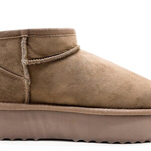 May include: A pair of brown suede ankle boots with a thick platform sole.