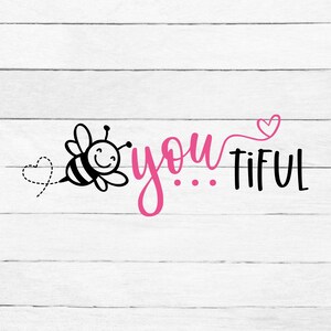 May include: A black and white cartoon bee with a smiling face and a dotted heart flies towards the pink word "you" followed by three dots and the black word "tiful". A pink heart is above the "i" in "tiful".